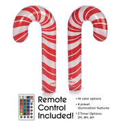 Two inflatable candy canes with a remote control on a white background